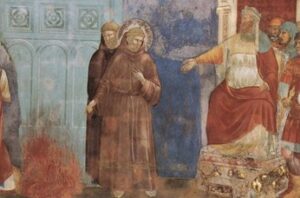Affresco con San Francesco d’Assisi, riconoscibile dal saio e dall’aureola, che si avvicina a un fuoco acceso sotto lo sguardo di un dignitario seduto e altri presenti. La scena raffigura l’incontro tra Francesco e il Sultano d’Egitto durante la quinta crociata. L’immagine è inserita nell’articolo per contestualizzare il viaggio in Medio Oriente, dove il Santo potrebbe aver contratto la malattia oculare che lo rese cieco. Il dipinto sottolinea il coraggio e la spiritualità di Francesco, anticipando il tema della sofferenza fisica e della cecità trattato nel testo.